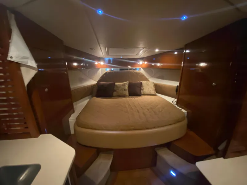 Slide: The Image of Luxurious cabin interior of 2009 Sea Ray 350 Sundancer with cozy bed and ambient lighting. - 37