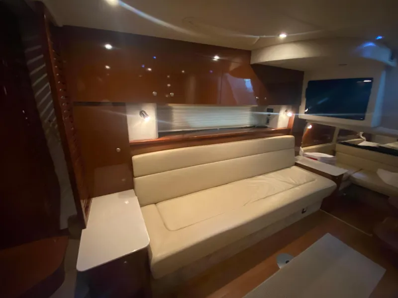Slide: The Image of Interior of 2009 Sea Ray 350 Sundancer yacht with beige seating and modern lighting. - 38