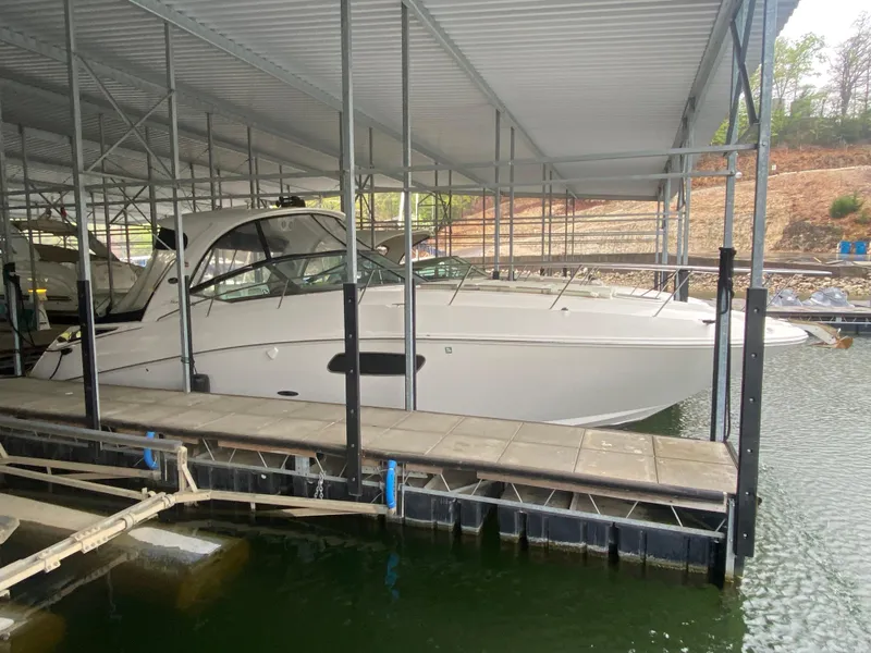 Slide: The Image of 2009 Sea Ray 350 Sundancer docked under a covered marina. - 4