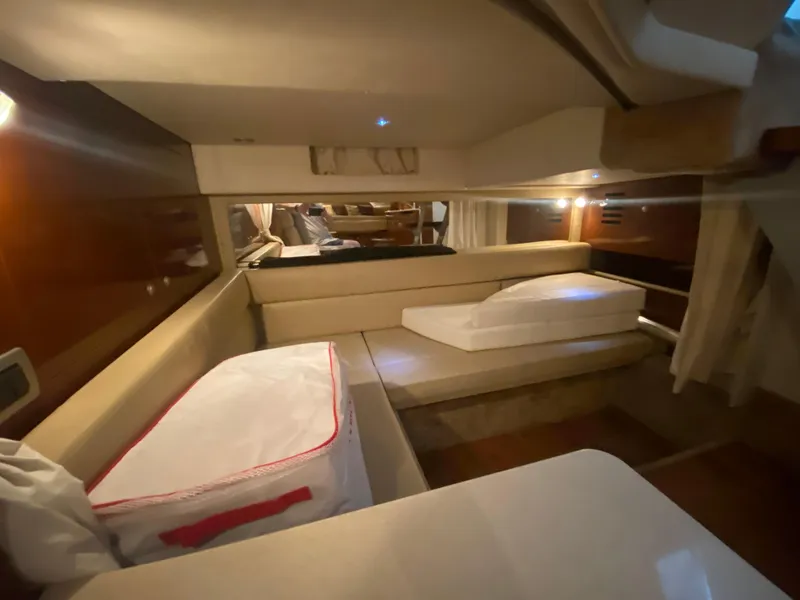 Slide: The Image of Interior cabin of 2009 Sea Ray 350 Sundancer with beige seating and ambient lighting. - 40