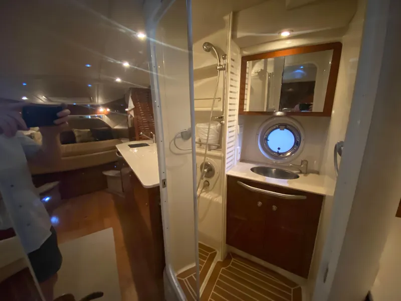 Slide: The Image of Interior of 2009 Sea Ray 350 Sundancer yacht, featuring a compact bathroom and cozy cabin. - 42
