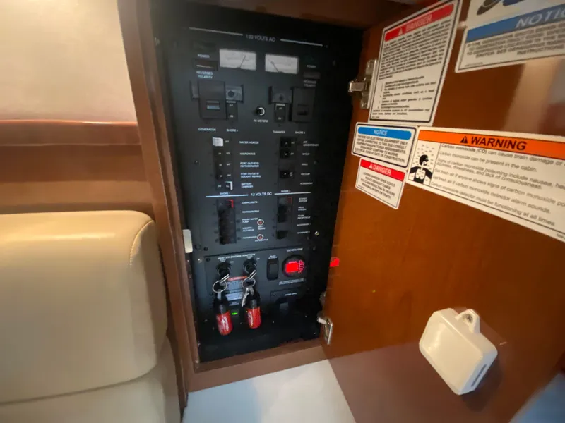 Slide: The Image of Electrical panel inside a 2009 Sea Ray 350 Sundancer boat cabin. - 44