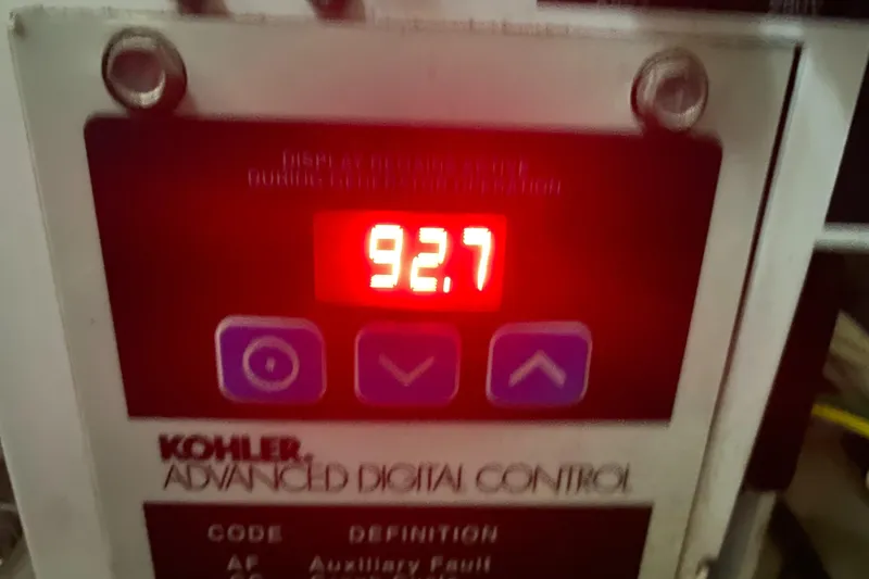 Slide: The Image of Kohler advanced digital control panel displaying 92.7 on a Sea Ray 350 Sundancer, 2009 model. - 48