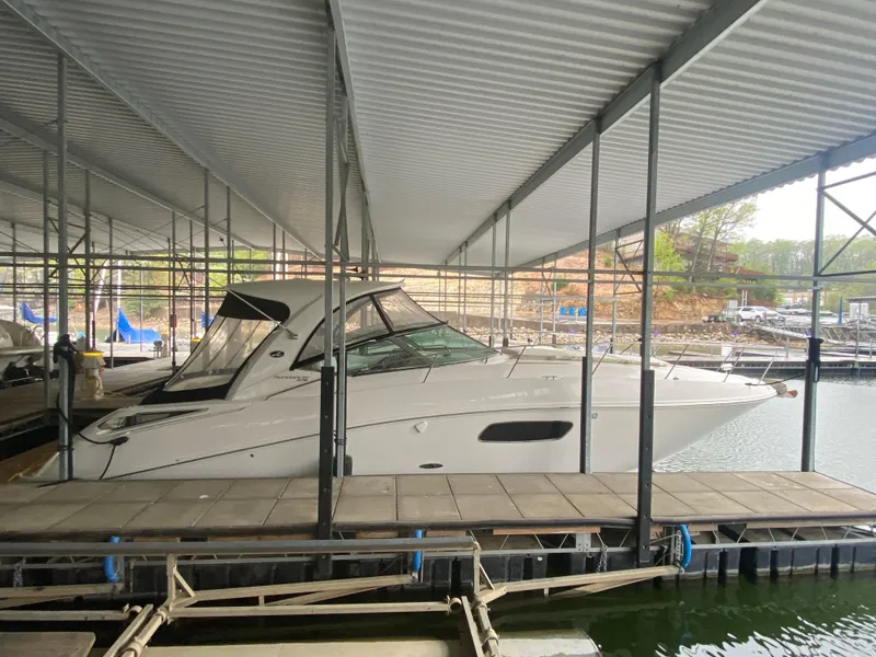 Slide: The Image of 2009 Sea Ray 350 Sundancer docked under a covered marina. - 49