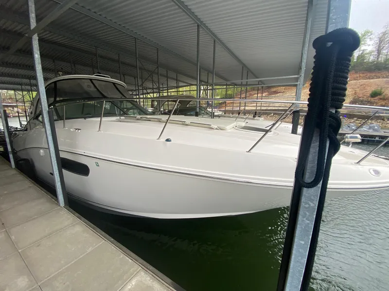 Slide: The Image of 2009 Sea Ray 350 Sundancer docked in a covered marina. - 6