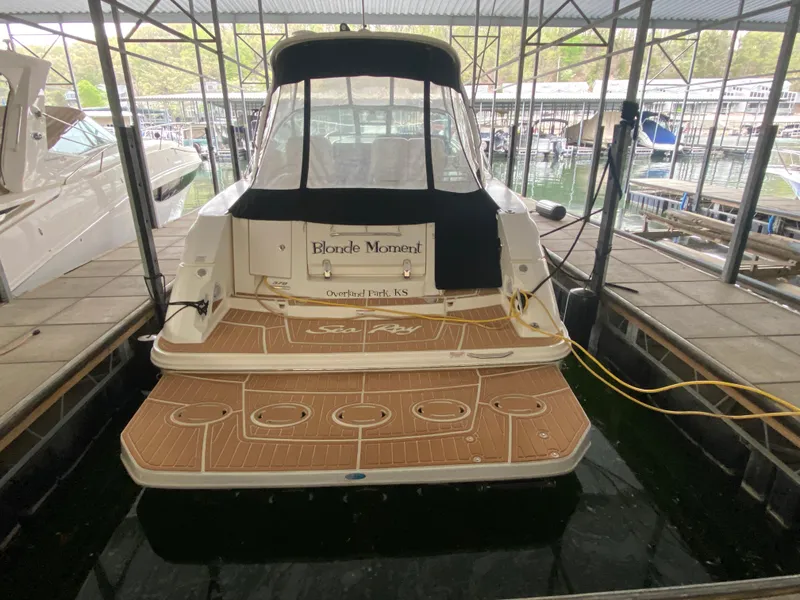 Slide: The Image of 2009 Sea Ray 350 Sundancer docked in a marina, rear view. - 8