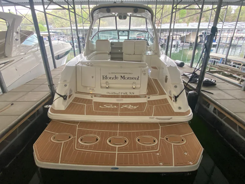 Slide: The Image of 2009 Sea Ray 350 Sundancer docked, featuring spacious deck and seating area. - 9