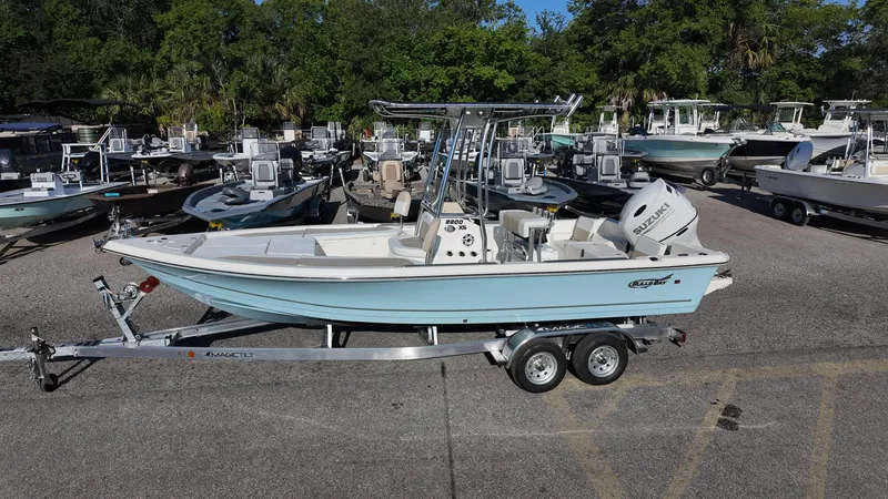 Slide: The Image of 2025 Bulls Bay 2200XS boat on trailer in marina setting. - 11