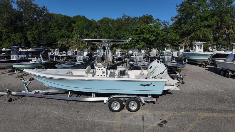 Slide: The Image of 2025 Bulls Bay 2200XS boat on trailer in marina parking lot. - 14