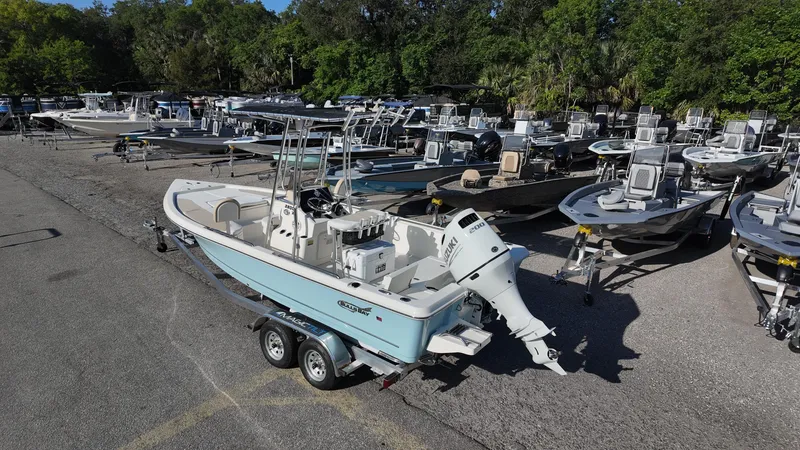 Slide: The Image of 2025 Bulls Bay 2200XS boat on trailer in a marina with multiple boats. - 20