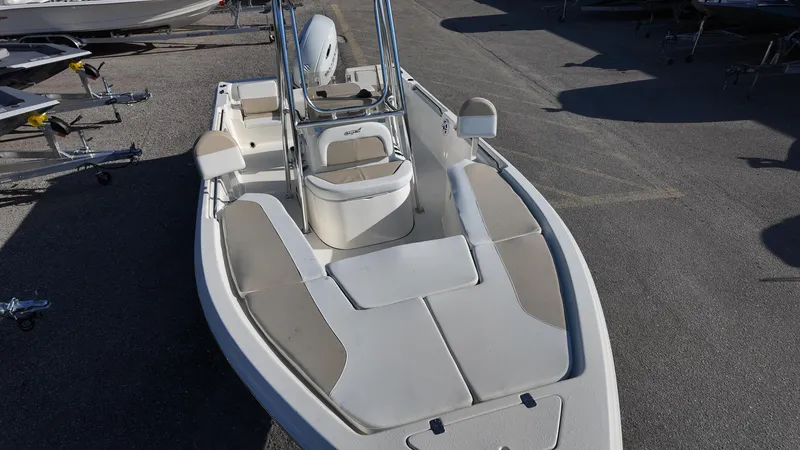 Slide: The Image of 2025 Bulls Bay 2200XS boat with spacious deck and seating, parked on a trailer. - 28