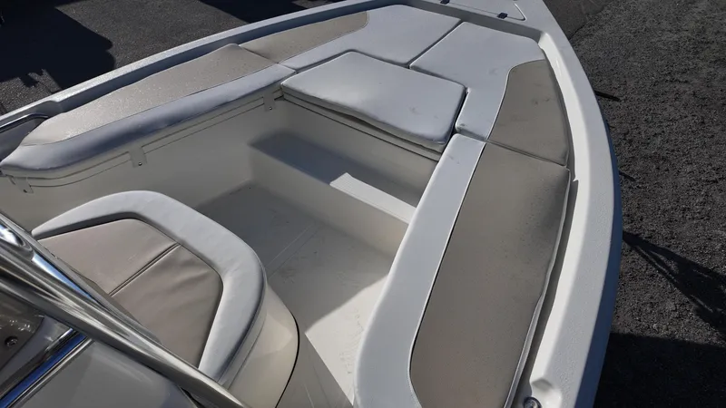 Slide: The Image of 2025 Bulls Bay 2200XS boat interior with cushioned seating and storage compartments. - 31