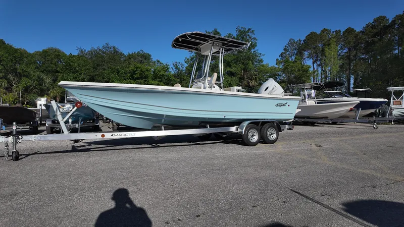 Slide: The Image of 2025 Bulls Bay 2200XS boat on trailer, parked outdoors under clear blue sky. - 6