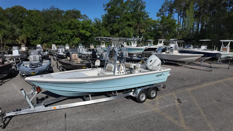 Slide: The Image of 2025 Bulls Bay 2200XS boat on trailer in a marina with other boats. - 8