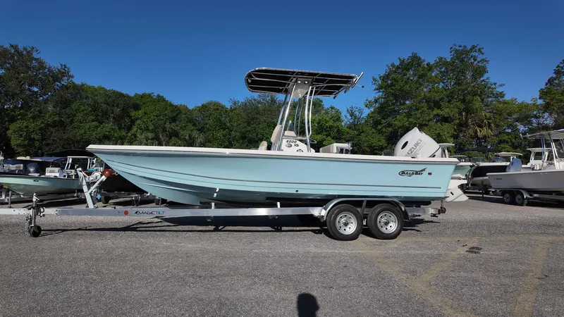 Slide: The Image of 2025 Bulls Bay 2200XS boat on trailer, parked outdoors under clear blue sky. - 9