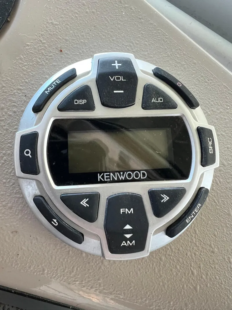Slide: The Image of Kenwood audio control panel on 2004 Doral Boca Grande 36 boat dashboard. - 11
