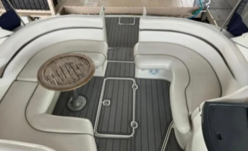 Slide: The Image of 2004 Doral Boca Grande 36 boat interior with curved seating and a round table. - 12
