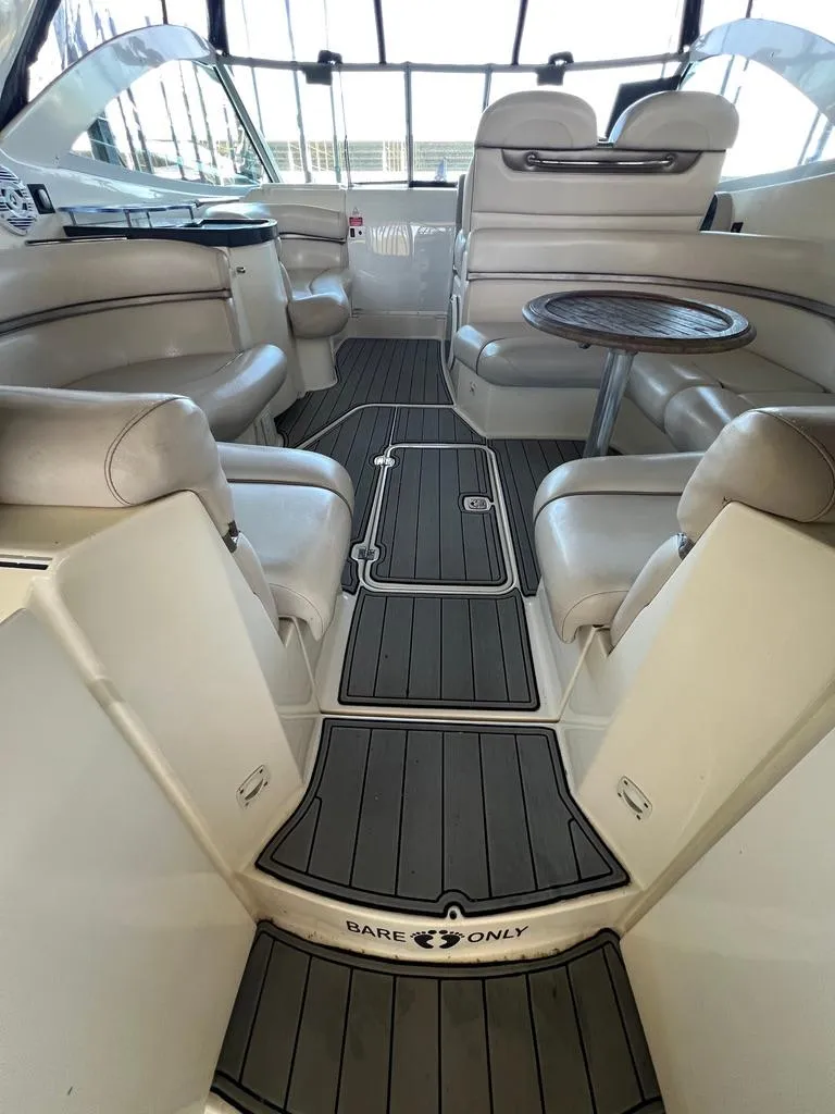 Slide: The Image of 2004 Doral Boca Grande 36 yacht interior with plush seating and wooden table. - 14