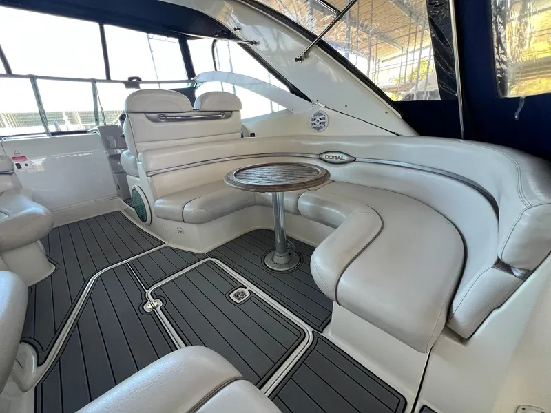 Slide: The Image of 2004 Doral Boca Grande 36 yacht interior with plush seating and wooden table. - 17