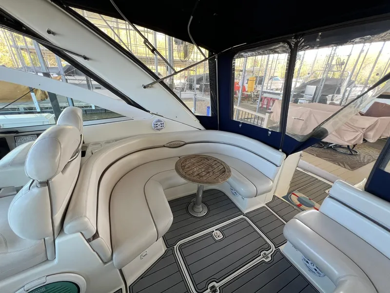 Slide: The Image of Interior of 2004 Doral Boca Grande 36 yacht with white seating and wooden table. - 18