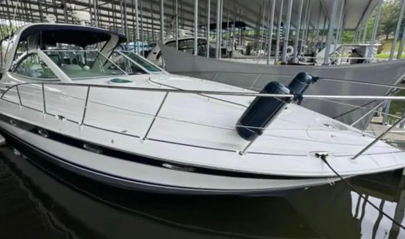 Slide: The Image of 2004 Doral Boca Grande 36 yacht docked in a marina under a covered structure. - 2