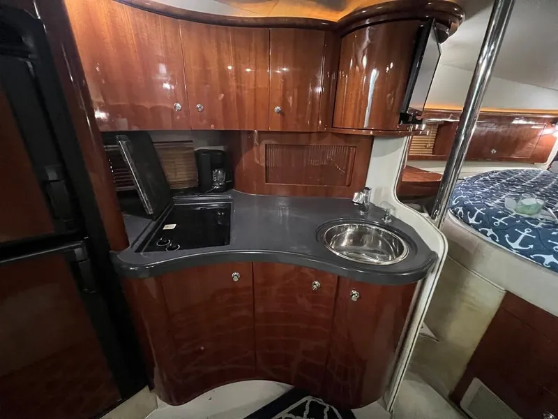 Slide: The Image of 2004 Doral Boca Grande 36 yacht interior with sleek kitchen and cozy sleeping area. - 21