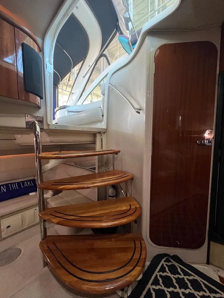Slide: The Image of Interior of 2004 Doral Boca Grande 36 yacht with wooden stairs and sleek design. - 22