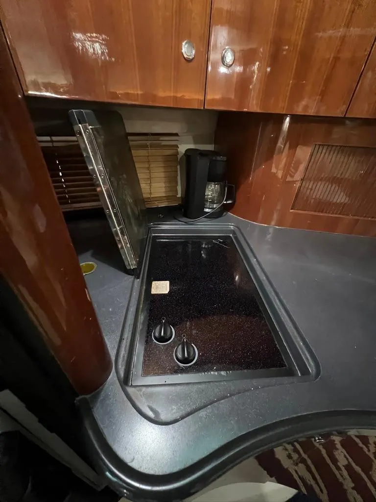 Slide: The Image of 2004 Doral Boca Grande 36 yacht kitchen with stove and wooden cabinets. - 23