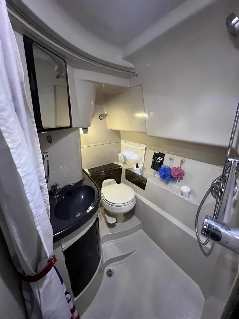 Slide: The Image of 2004 Doral Boca Grande 36 boat bathroom with sink, toilet, and shower amenities. - 30