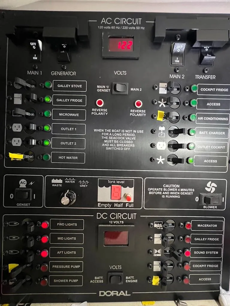 Slide: The Image of Electrical control panel of a 2004 Doral Boca Grande 36 boat, showing AC and DC circuits. - 33