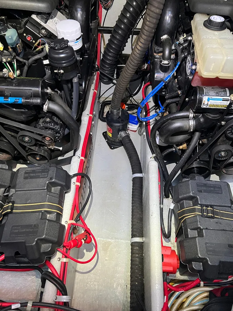 Slide: The Image of Engine compartment of a 2004 Doral Boca Grande 36 boat, showcasing dual engines and components. - 37