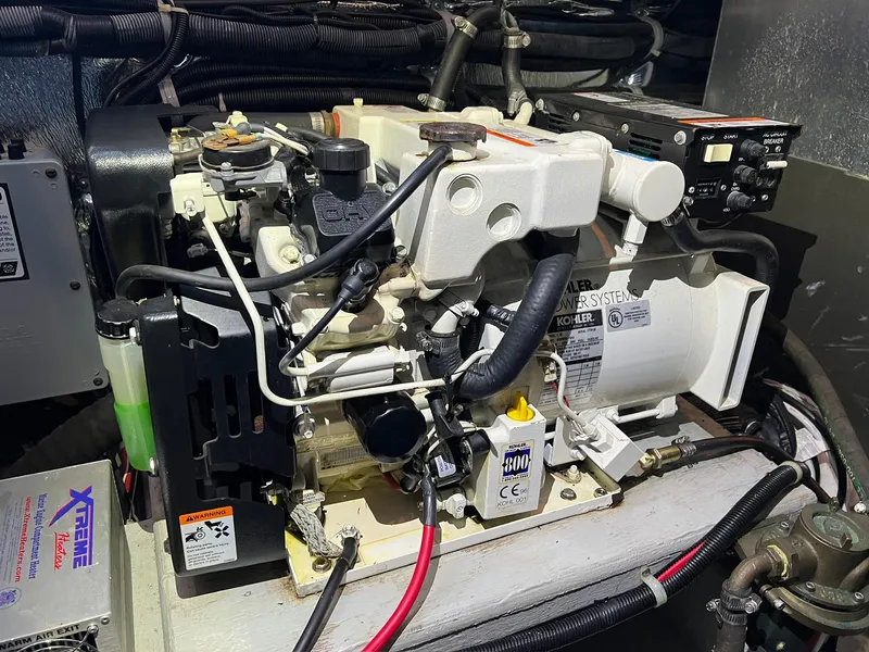 Slide: The Image of Engine compartment of a 2004 Doral Boca Grande 36 boat, featuring Kohler power systems. - 38