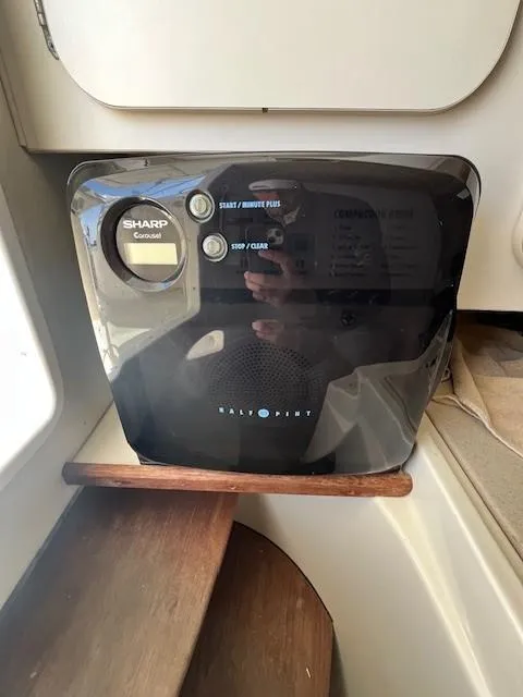 Slide: The Image of Sharp Carousel microwave inside 2003 Pursuit 2870 Walkaround boat cabin. - 14