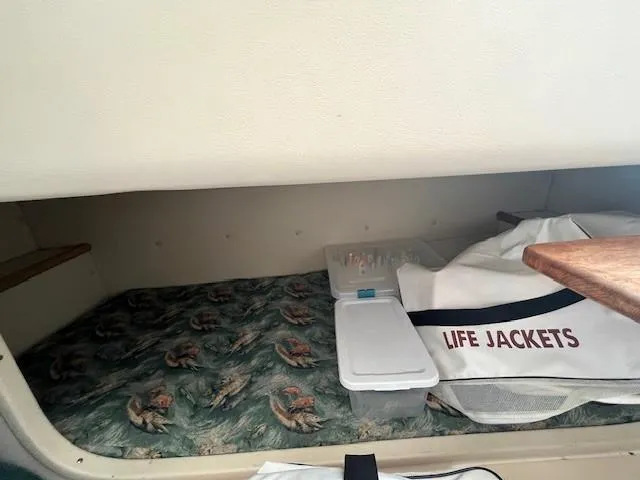 Slide: The Image of Interior cabin of 2003 Pursuit 2870 Walkaround with life jackets and storage. - 20