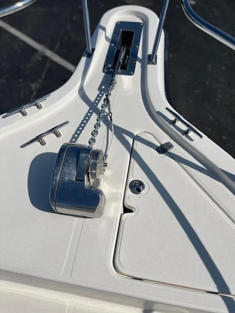 Slide: The Image of 2003 Pursuit 2870 Walkaround boat anchor chain and winch on deck. - 22