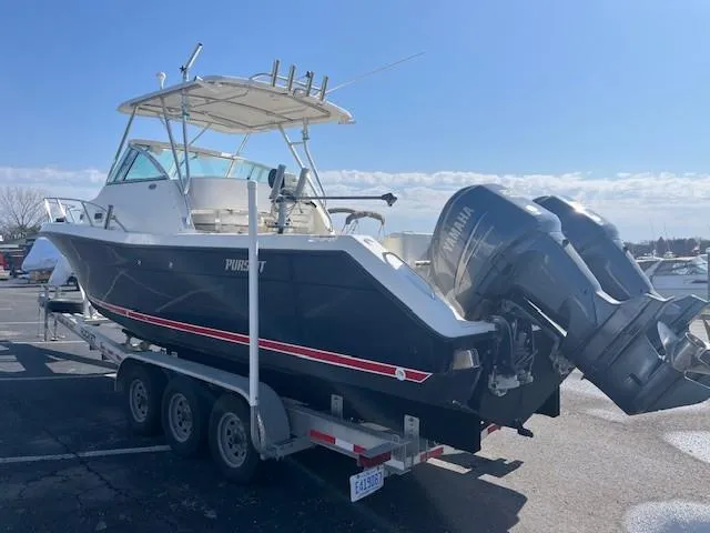 Slide: The Image of 2003 Pursuit 2870 Walkaround boat on trailer, featuring dual outboard engines. - 4