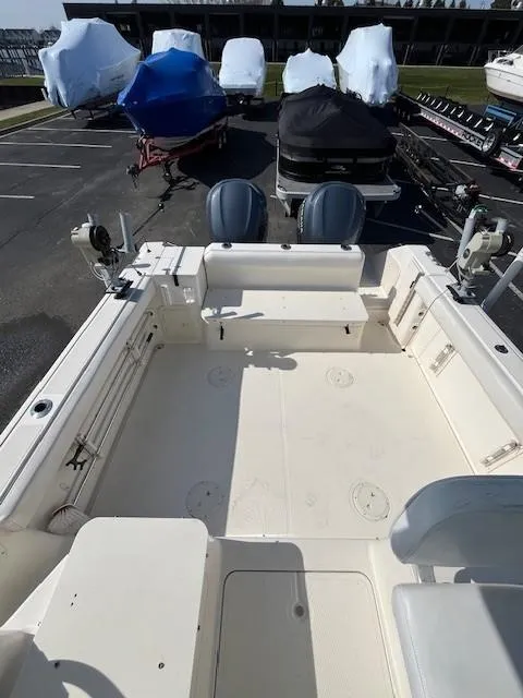 Slide: The Image of 2003 Pursuit 2870 Walkaround boat with dual engines, docked in a marina. - 7
