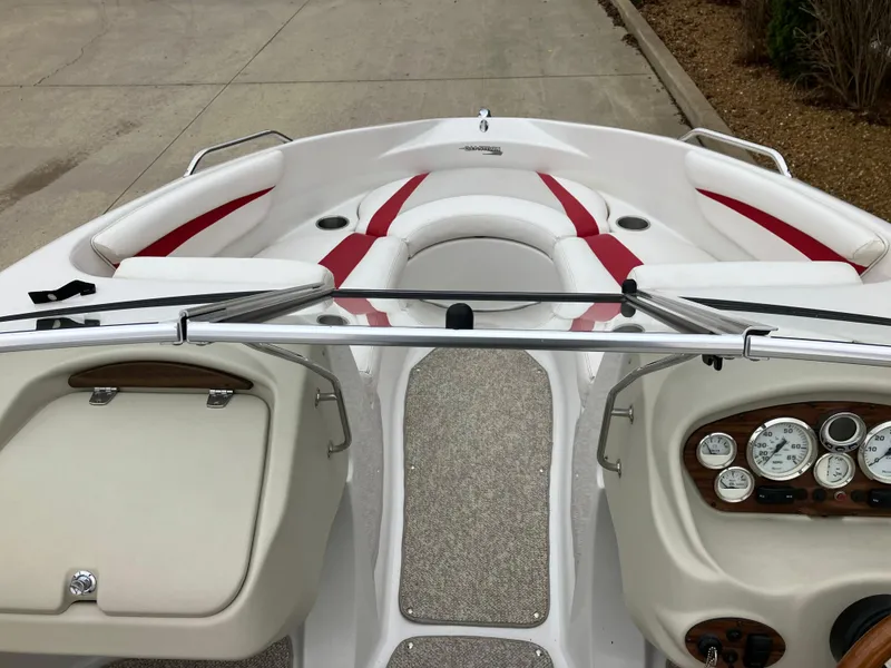 Slide: The Image of 2011 Glastron GT 205 boat interior with red and white seating, dashboard, and steering wheel. - 10