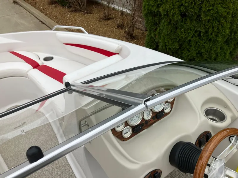 Slide: The Image of 2011 Glastron GT 205 boat interior with red accents and dashboard controls. - 12