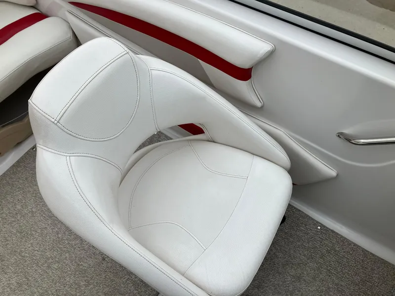 Slide: The Image of White interior seating of 2011 Glastron GT 205 boat with red accents. - 8
