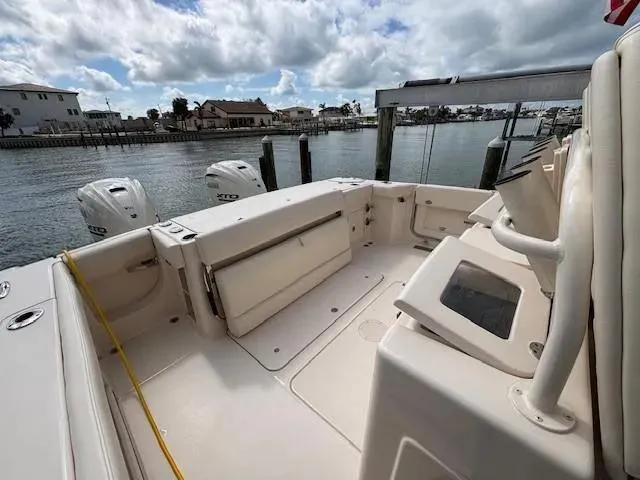 Slide: The Image of 2024 Grady-White Canyon 336 boat docked, featuring spacious deck and dual outboard motors. - 13