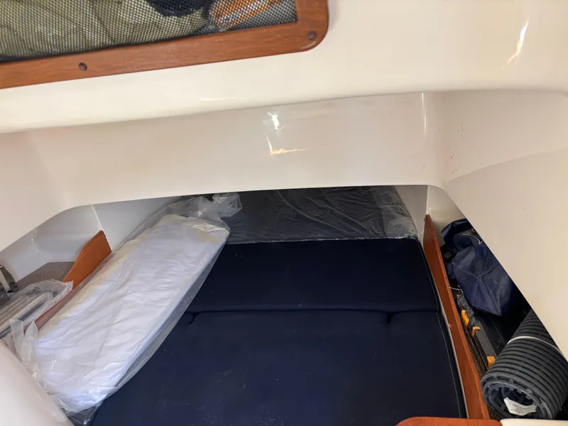 Slide: The Image of 2024 Grady-White Canyon 336 cabin interior with bedding and storage space. - 18