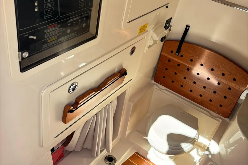 Slide: The Image of 2024 Grady-White Canyon 336 boat interior with control panel and seating area. - 19