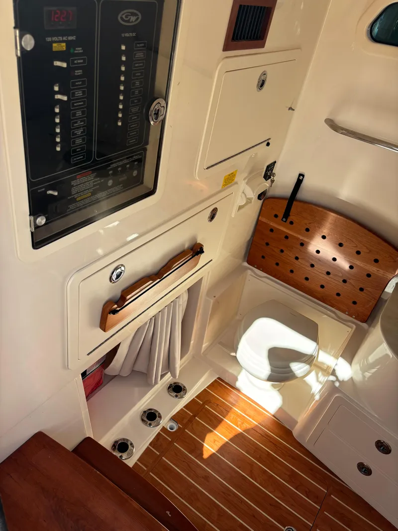 Slide: The Image of 2024 Grady-White Canyon 336 interior with control panel and wooden flooring. - 29