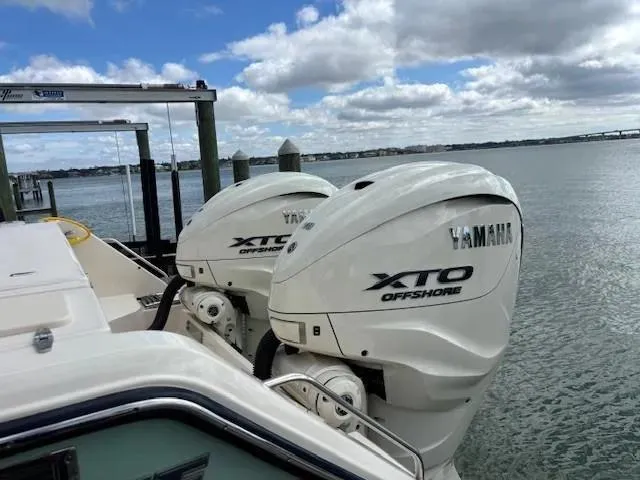 Slide: The Image of 2024 Grady-White Canyon 336 with Yamaha XTO Offshore engines docked by the water. - 4