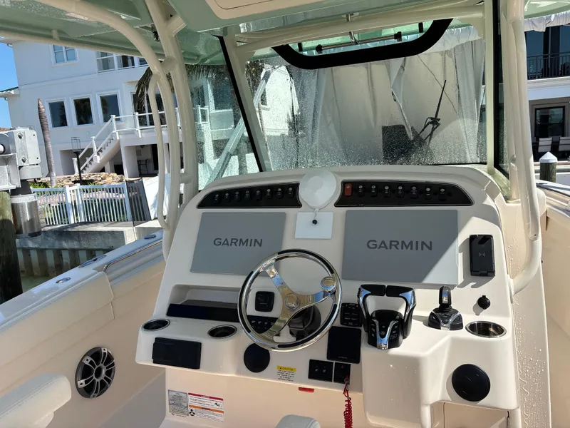 Slide: The Image of 2024 Grady-White Canyon 336 boat dashboard with Garmin navigation systems. - 7