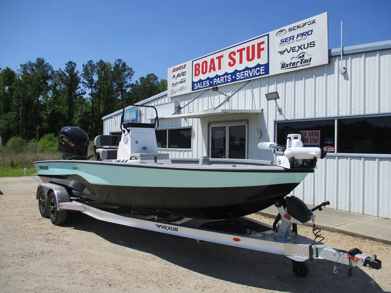 Slide: The Image of 2025 Vexus ACX 2210 boat on trailer outside dealership, "Boat Stuff" sign visible. - 1