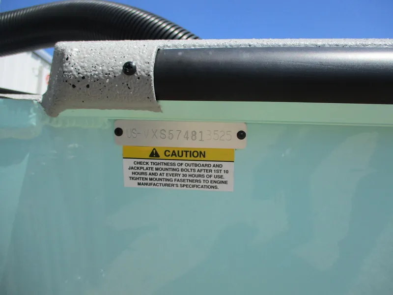 Slide: The Image of 2025 Vexus ACX 2210 caution label on boat hull, emphasizing bolt tightness checks. - 14