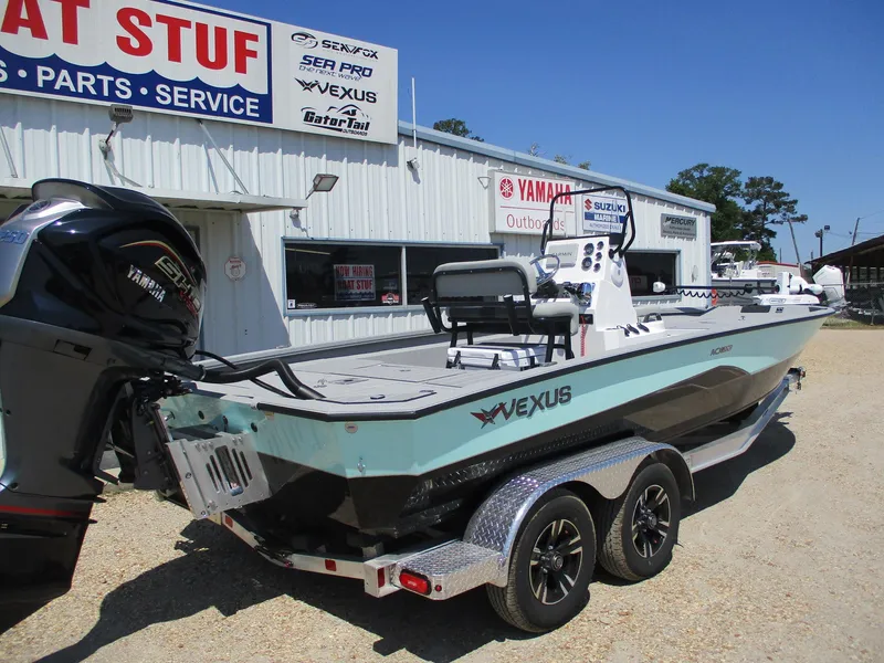 Slide: The Image of 2025 Vexus ACX 2210 boat on trailer outside dealership, featuring Yamaha outboard motor. - 4