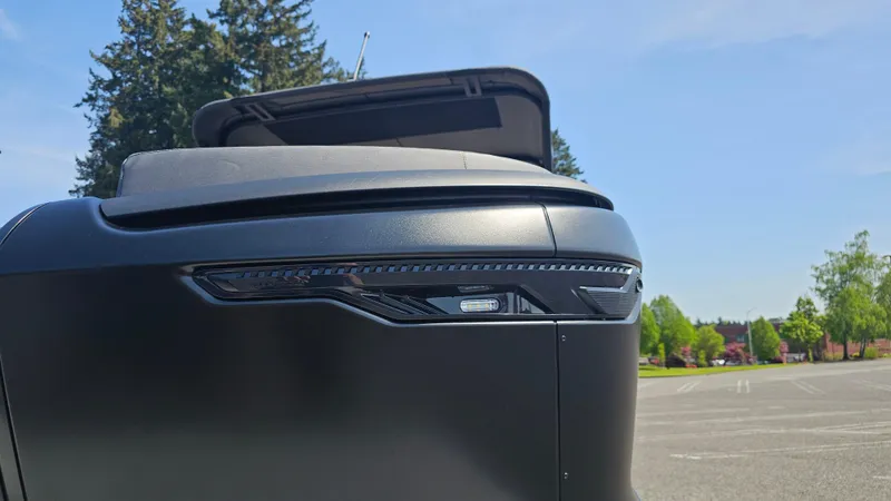 Slide: The Image of 2025 Manitou 24' Explore MAX Deck Navigator with 150hp Rotax Stealth Motor, sleek design detail. - 29